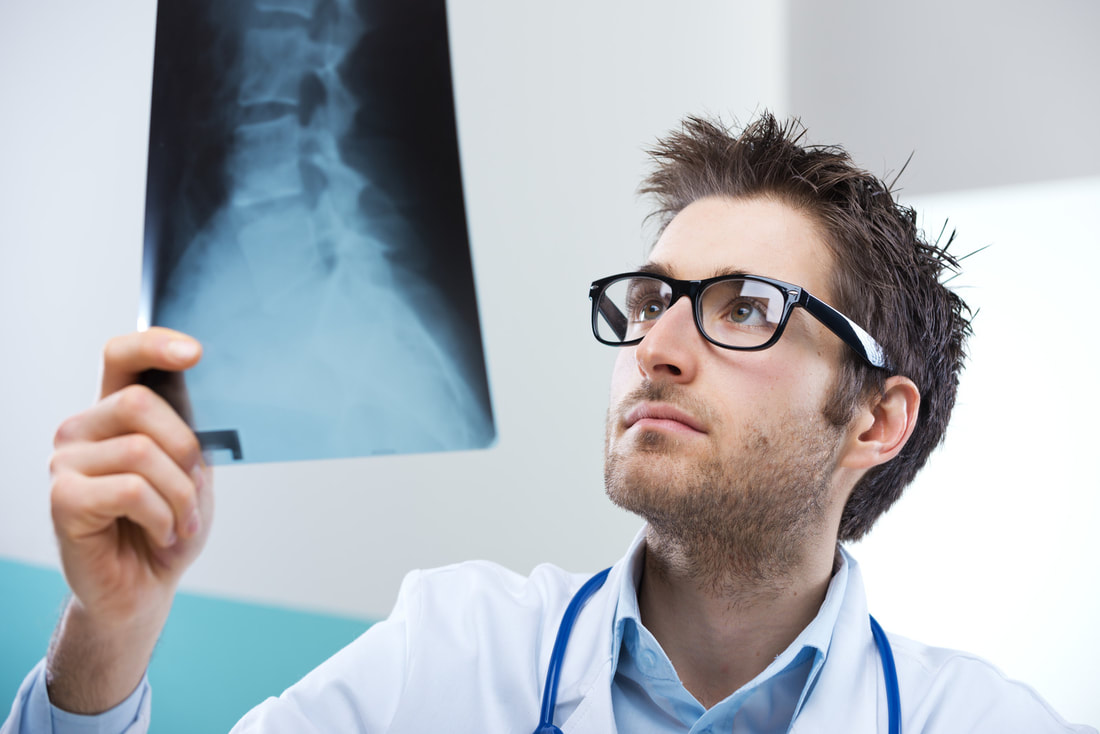 man in glasses holding xray